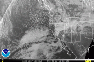 Current satellite imagery shows a rapidly developing surface low (with baroclinic leaf cloud) west of California. (NOAA SSD)